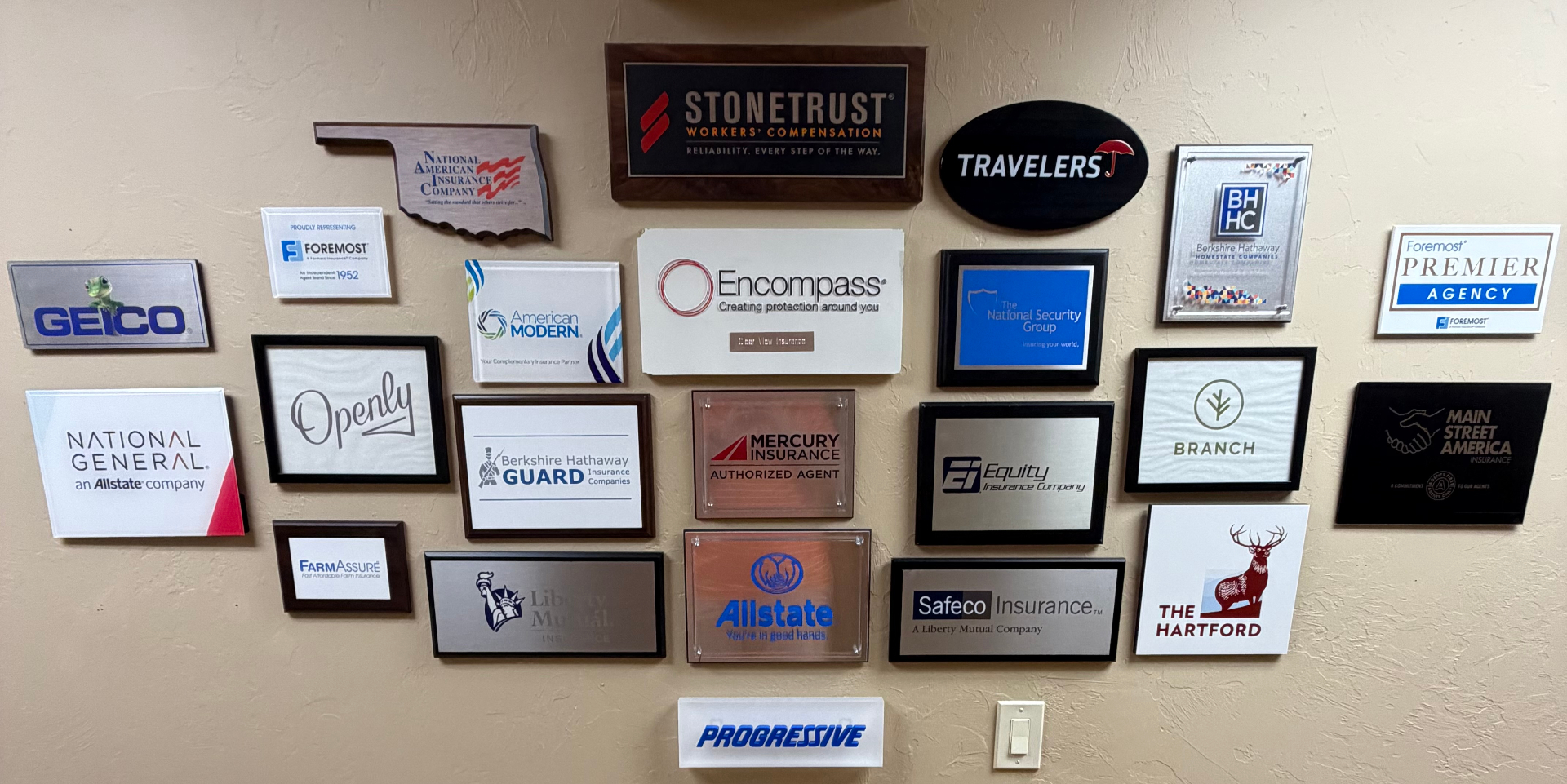 Wall of carrier partner plaques at Clear View Insurance
