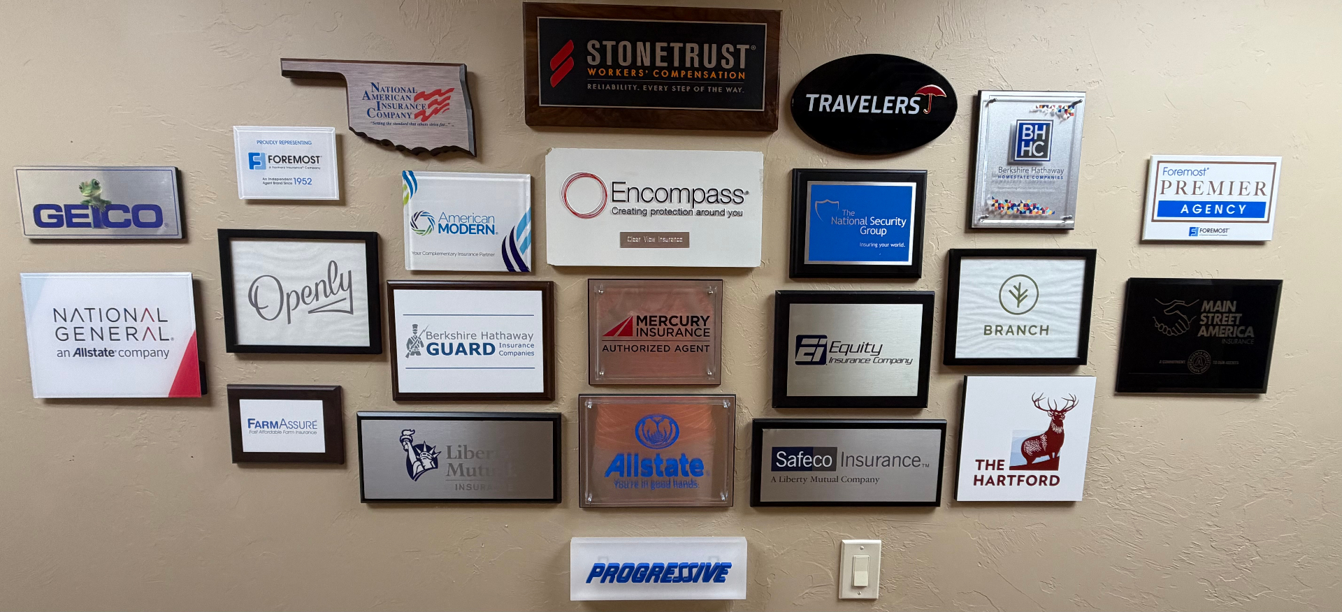 Wall of carrier partner plaques at Clear View Insurance