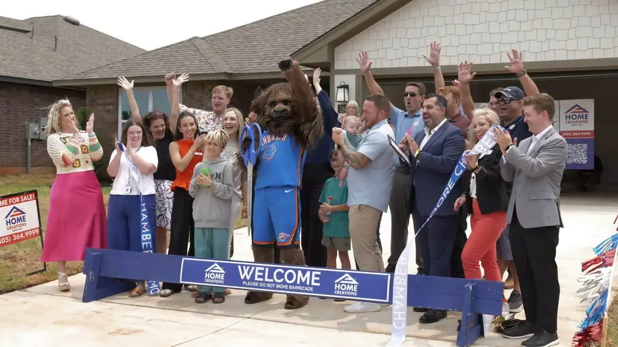 Chamber ribbon cutting at a new model home — Rumble the Bison included