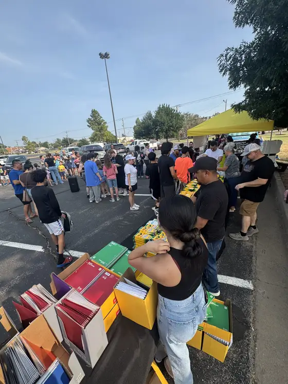 Handing out school supplies at a community back-to-school drive