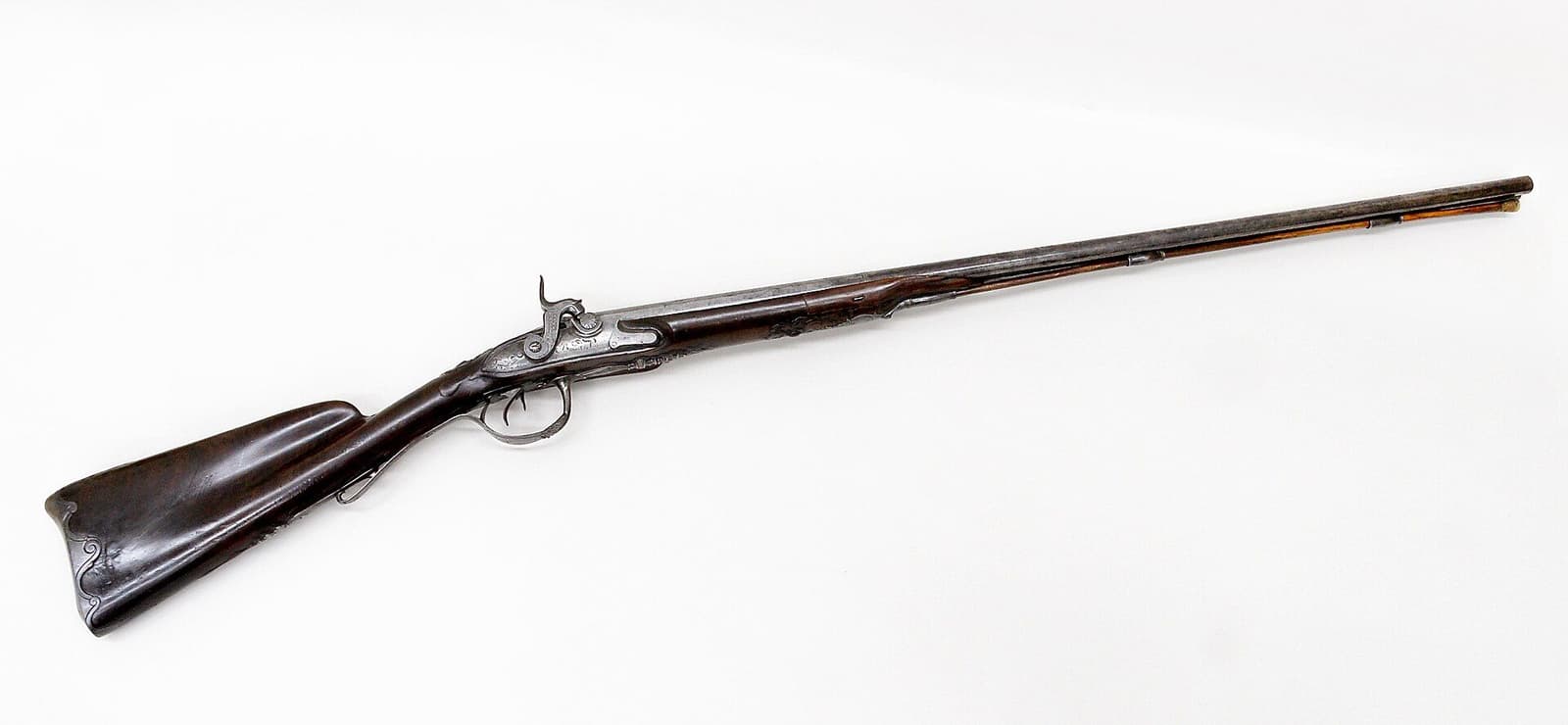 A classic double-barreled shotgun on a white background