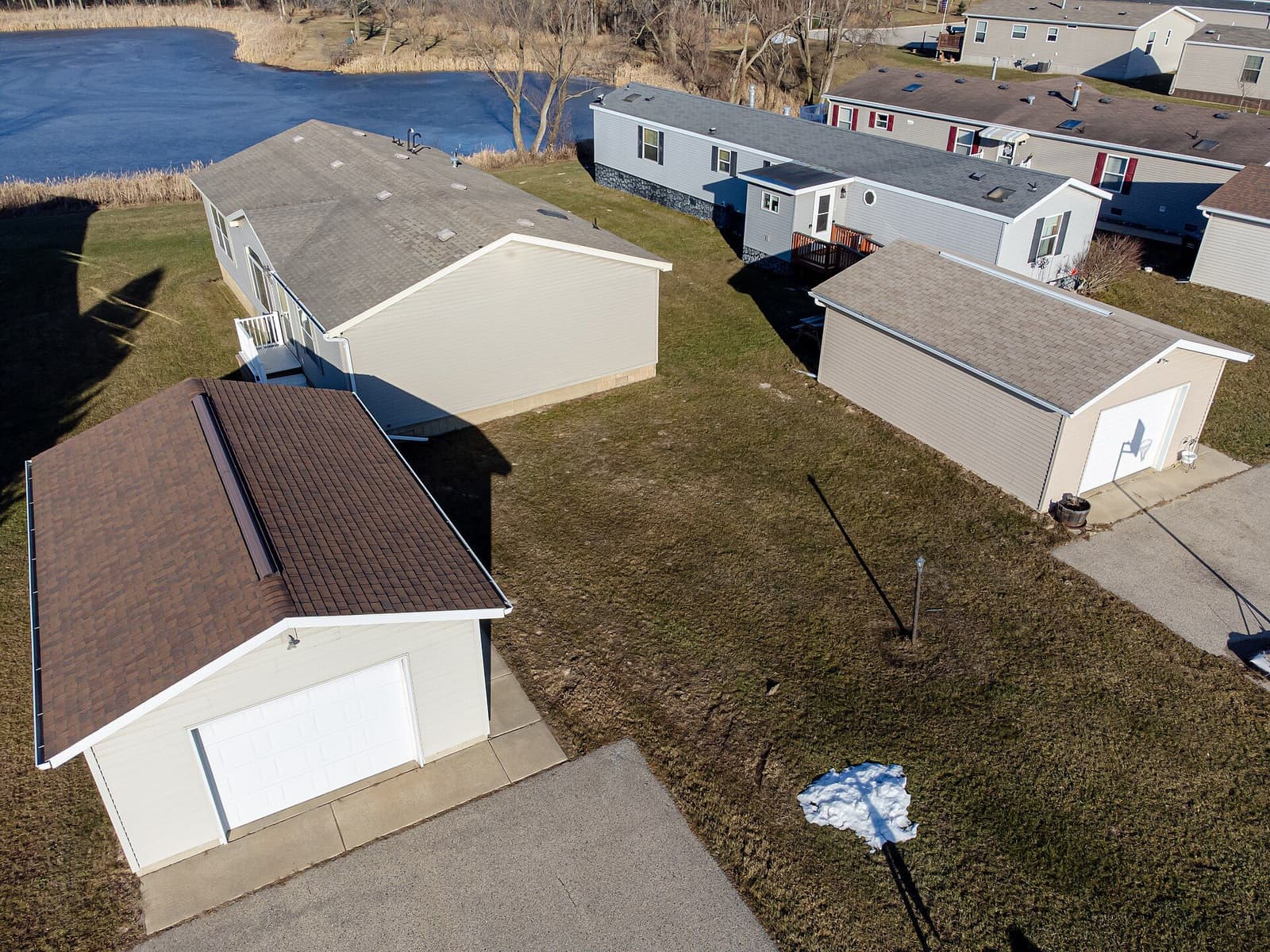 Manufactured homes with detached garages, seen from above
